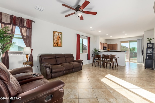 tiled living room with ceiling fan