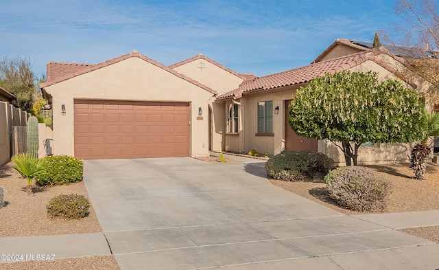 mediterranean / spanish house featuring a garage