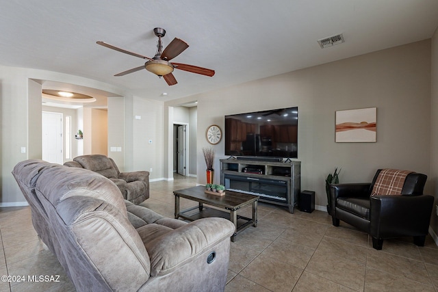 tiled living room featuring ceiling fan