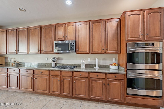 kitchen with light tile patterned floors and appliances with stainless steel finishes