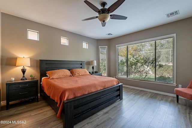 bedroom with ceiling fan and hardwood / wood-style floors