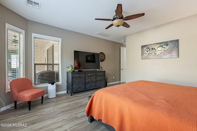 bedroom with ceiling fan and light hardwood / wood-style floors