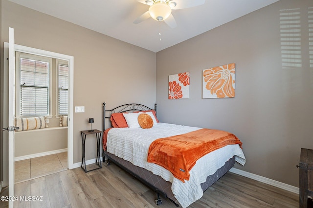 bedroom featuring hardwood / wood-style floors and ceiling fan