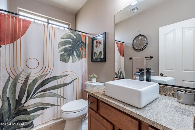 bathroom featuring toilet, vanity, and tile patterned floors