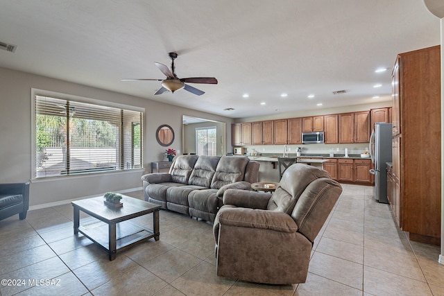 tiled living room with ceiling fan