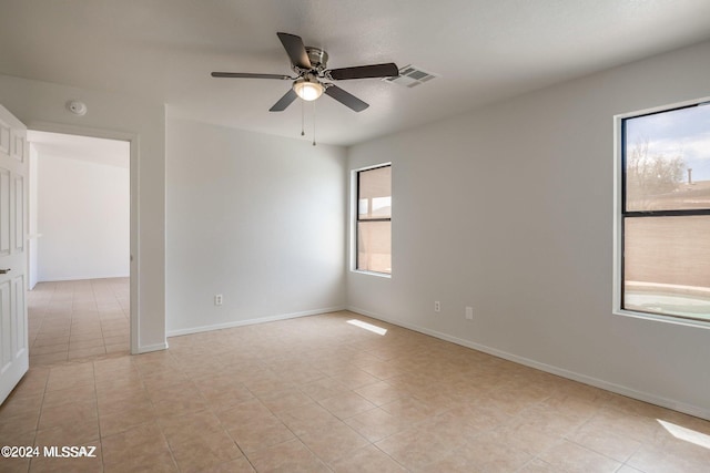 unfurnished room featuring ceiling fan and light tile patterned flooring