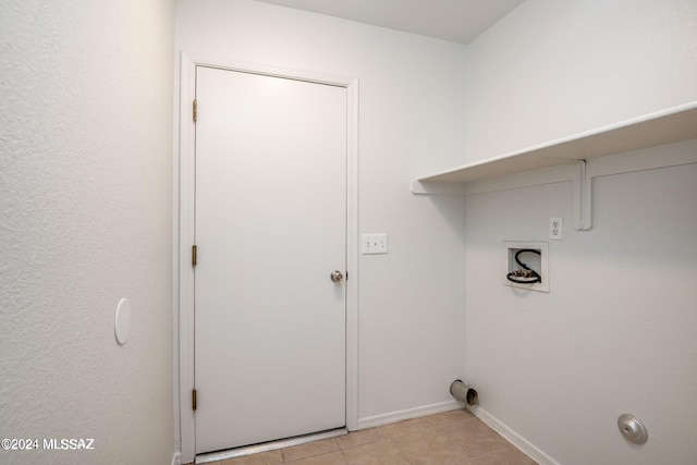 laundry area with washer hookup and light tile patterned floors