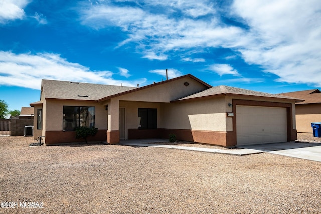 view of front of house featuring a garage and central air condition unit