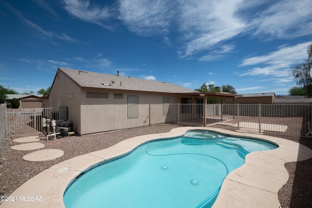 view of pool featuring an in ground hot tub