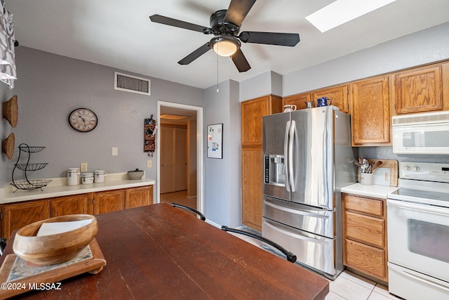 kitchen with ceiling fan, light tile patterned floors, and white appliances