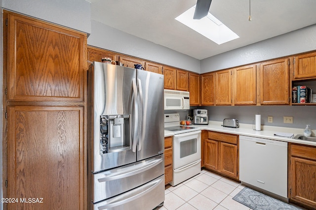 kitchen featuring white appliances and light tile patterned floors