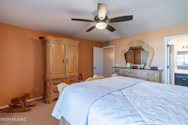 carpeted bedroom with connected bathroom, a textured ceiling, and ceiling fan