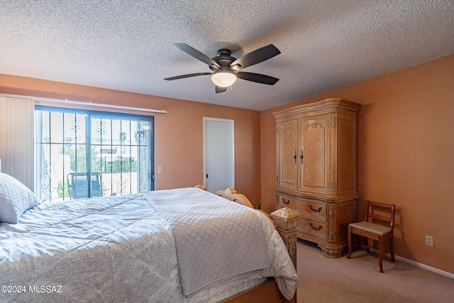 carpeted bedroom featuring access to exterior, ceiling fan, and a textured ceiling