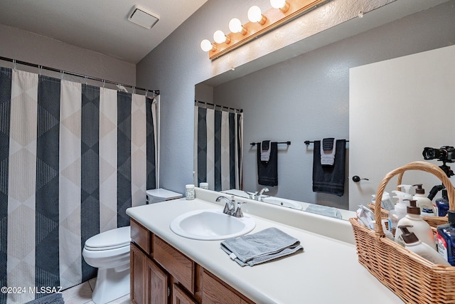 bathroom with tile patterned floors, toilet, and vanity