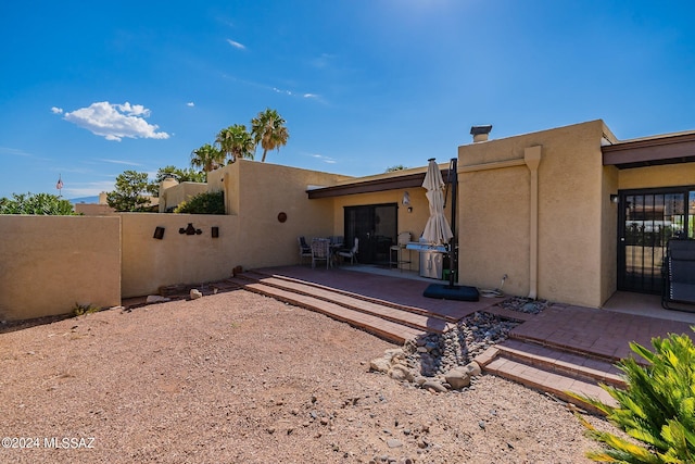 back of property with a patio