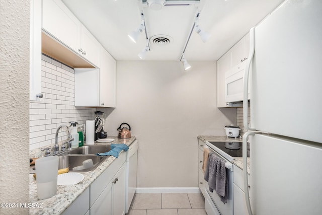 kitchen featuring decorative backsplash, white cabinetry, light tile patterned flooring, sink, and white appliances