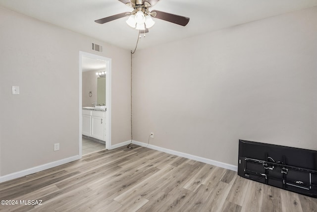 spare room featuring light hardwood / wood-style flooring and ceiling fan