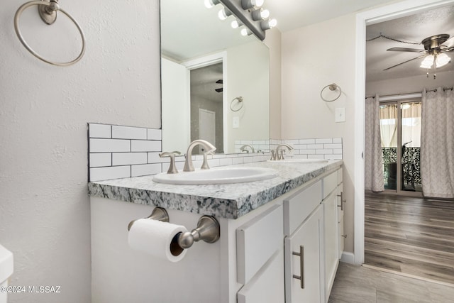 bathroom with vanity, hardwood / wood-style flooring, and ceiling fan