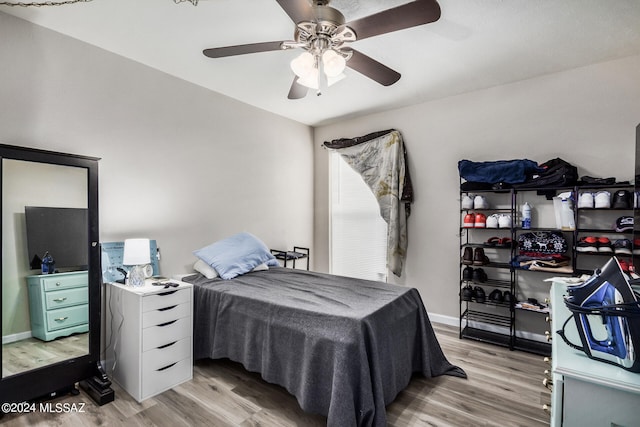 bedroom with light wood-type flooring and ceiling fan