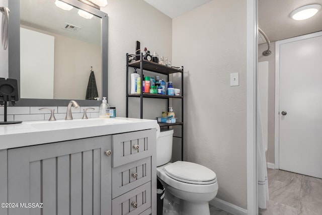 bathroom with vanity and toilet