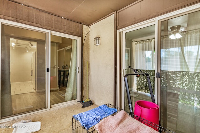 exterior space featuring ceiling fan and wood-type flooring