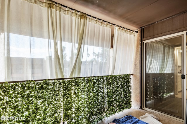 bathroom featuring wooden walls