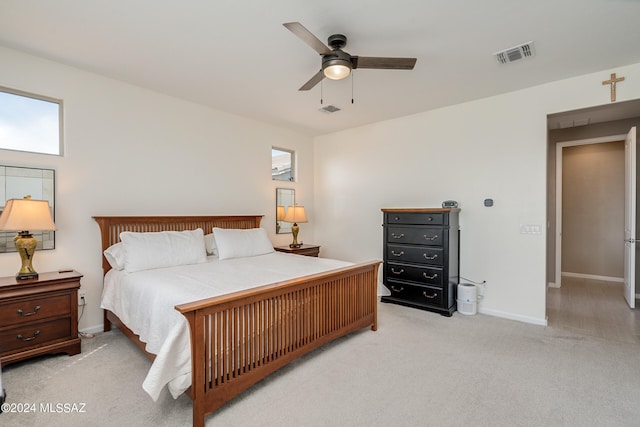 bedroom with light colored carpet and ceiling fan