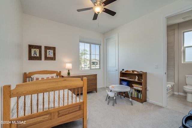 bedroom with ceiling fan, carpet, ensuite bath, and multiple windows