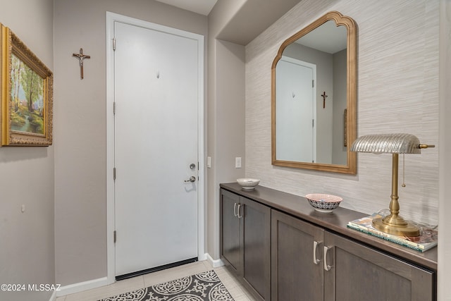 doorway to outside with light tile patterned floors