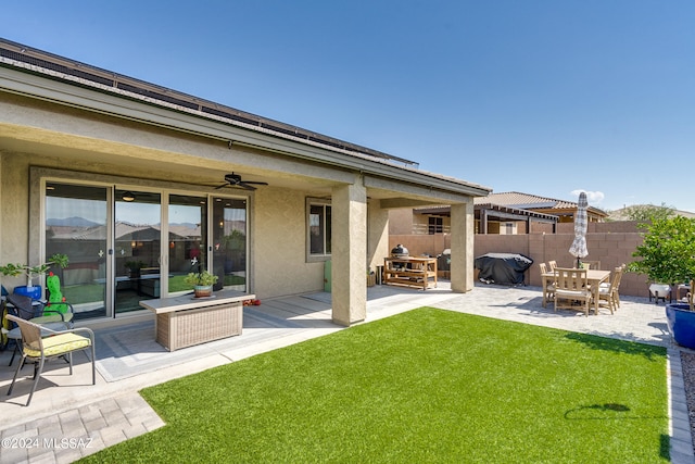 back of house with a yard, ceiling fan, and a patio area