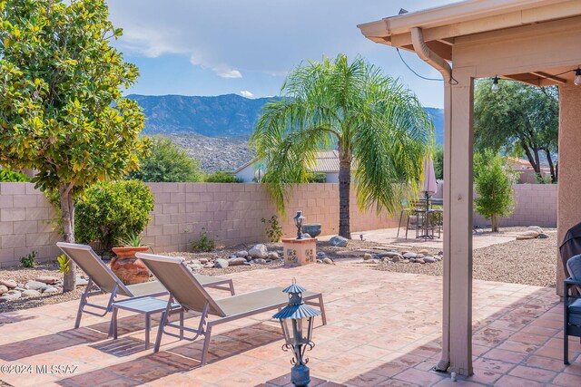 view of patio / terrace featuring a mountain view and a fenced backyard