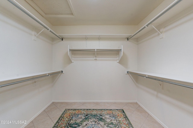 spacious closet featuring light tile patterned floors