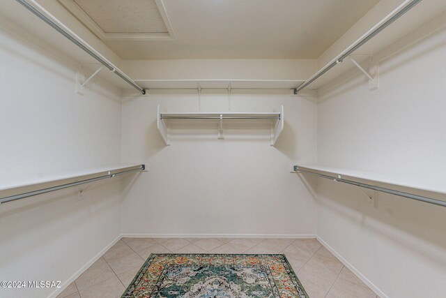 spacious closet with light tile patterned floors