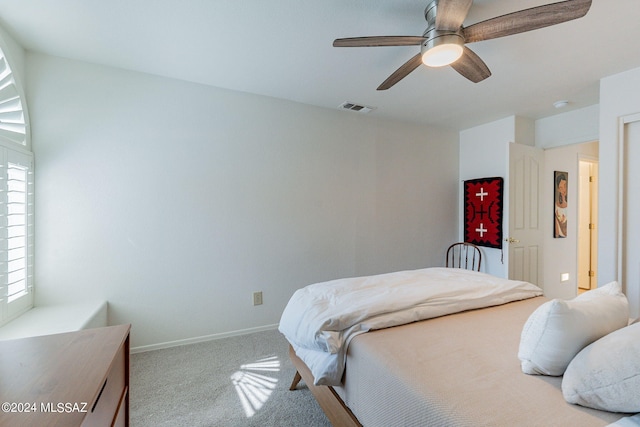 bedroom with light carpet, multiple windows, and ceiling fan