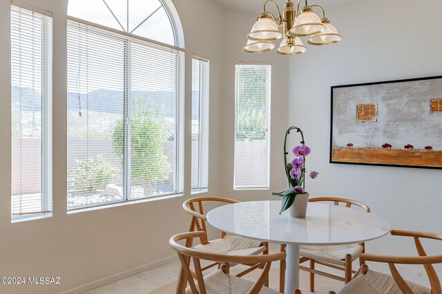 dining space featuring an inviting chandelier and baseboards