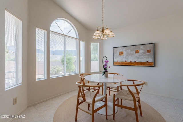 tiled dining space with lofted ceiling and a notable chandelier