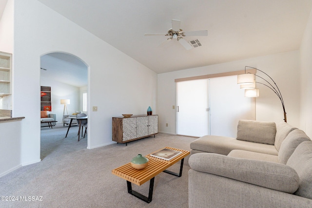 living room featuring ceiling fan, light colored carpet, and vaulted ceiling