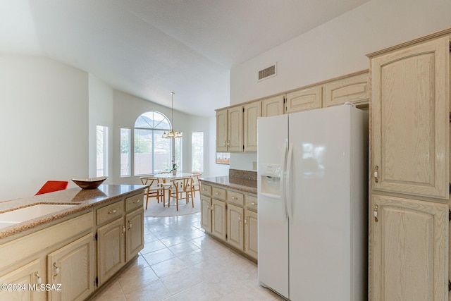 kitchen with a chandelier, white refrigerator with ice dispenser, light brown cabinetry, lofted ceiling, and light tile patterned floors