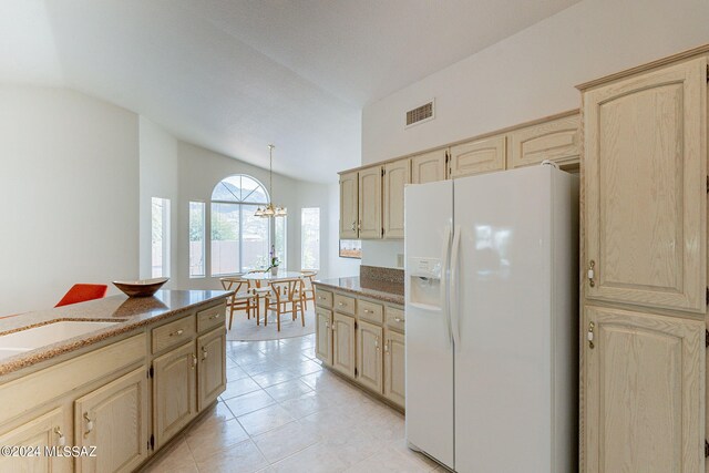 kitchen with white refrigerator with ice dispenser, light tile patterned floors, stone counters, visible vents, and lofted ceiling