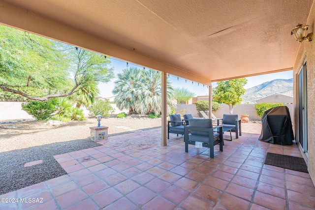 view of patio featuring a mountain view and an outdoor living space