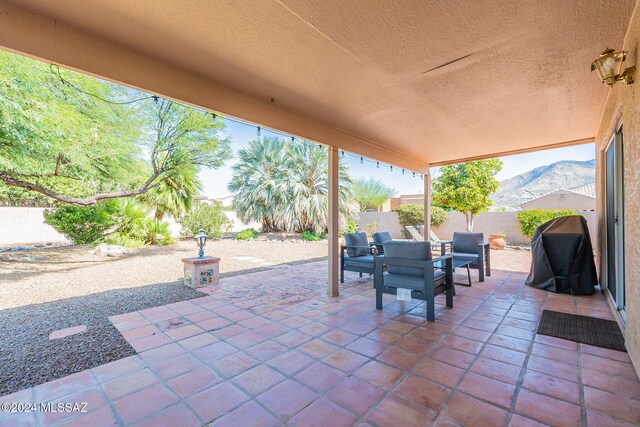 view of patio / terrace featuring outdoor dining space, a grill, and a fenced backyard