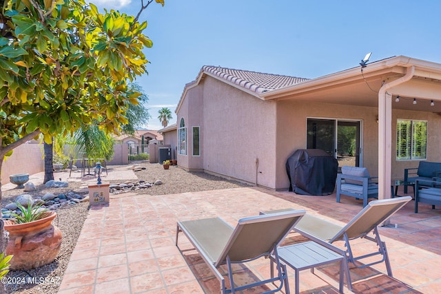 view of patio with fence, cooling unit, and a grill