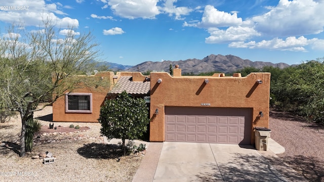 southwest-style home with a mountain view and a garage