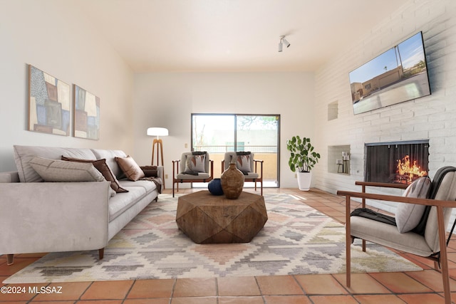 tiled living room with a brick fireplace