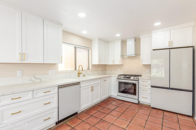 kitchen featuring wall chimney exhaust hood, white cabinetry, stainless steel gas range oven, dishwasher, and white fridge