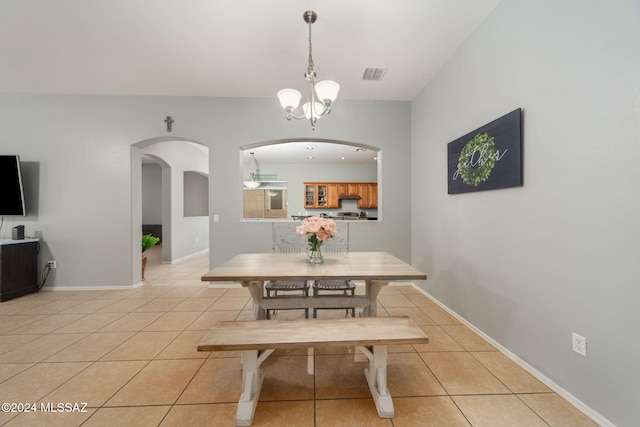 dining room featuring visible vents, an inviting chandelier, baseboards, arched walkways, and light tile patterned floors
