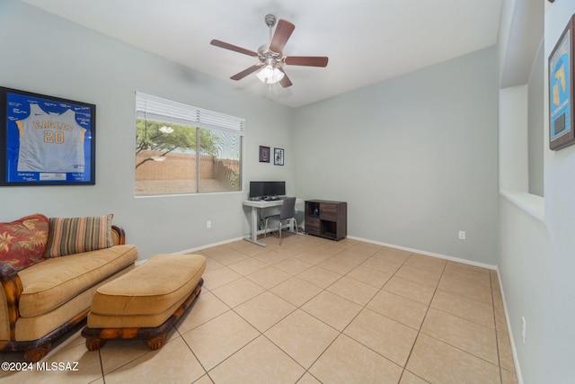 sitting room with light tile patterned floors, baseboards, and ceiling fan