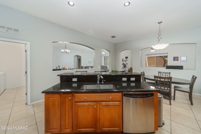 kitchen featuring visible vents, arched walkways, dishwasher, a sink, and light tile patterned floors