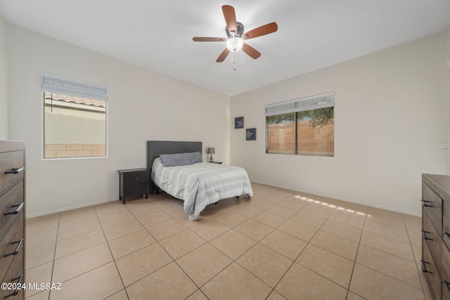 bedroom featuring light tile patterned flooring, baseboards, and ceiling fan