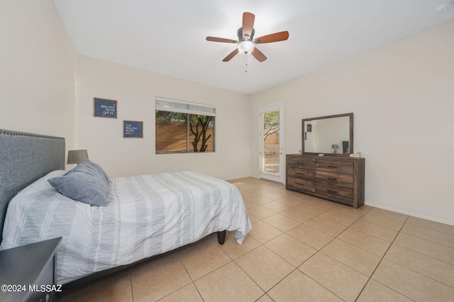 bedroom featuring ceiling fan, light tile patterned flooring, and access to exterior